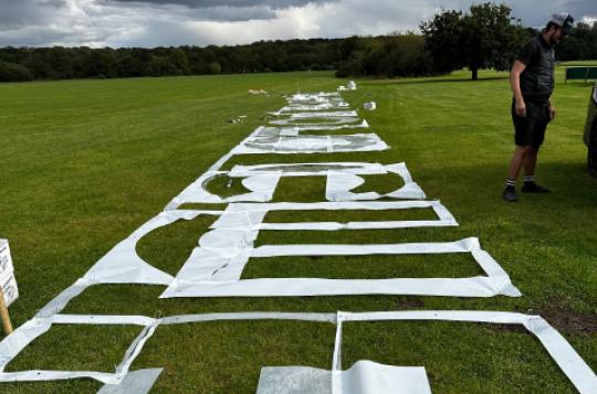 Extra large grass stencil used as event branding for the Aviation Polo Cup