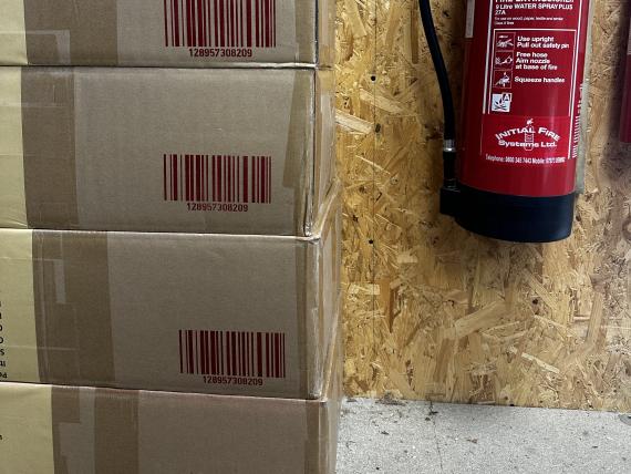 4 boxes stacked with barcode stencilled for identification