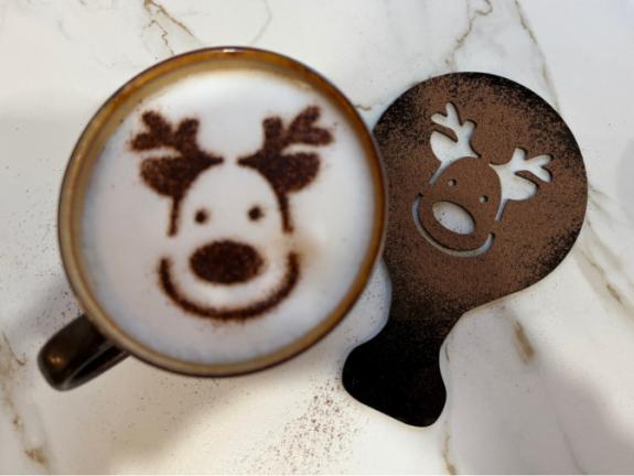 Reindeer design on late coffed with stencil in the background