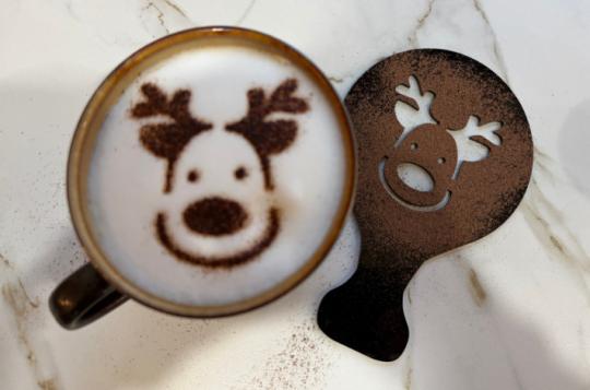 Reindeer design on late coffed with stencil in the background