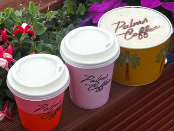 Palms coffee branded cups and coffee stencilled with chocolate powder