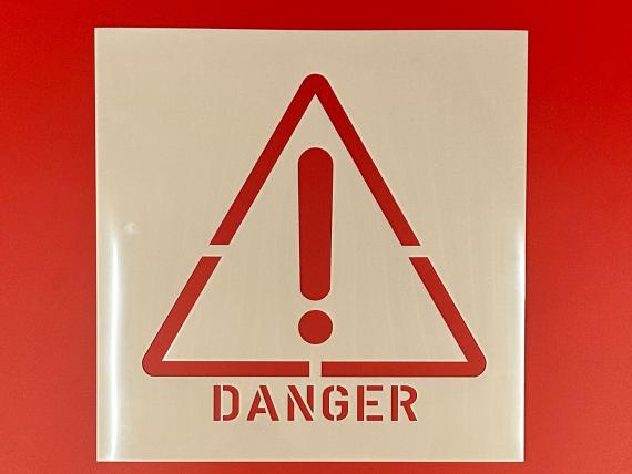 Danger stencil with Exclamation Mark in Triangle to indicate caution should be exercised