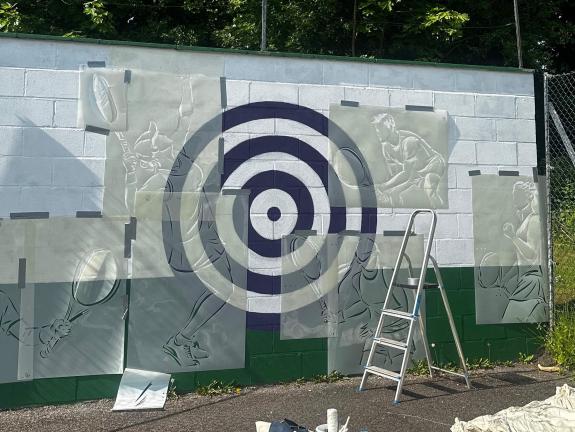 Stencils being used to create a Wall Mural for a Tennis Club
