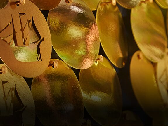 Christmas window display featuring thousands of laser cut paper baubles for Liberty of London