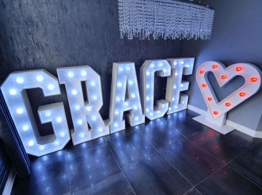 Large letters spelling Grace with a love heart, all illuminated with individual bulbs inset in the letters and heart