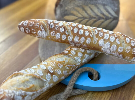 2 baguettes and loaf of real bread with stencil decoration