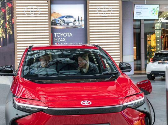 Panels created for MSI Global shown behind a red Toyota