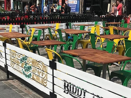Biddy Mulligan's outdoor bar seating area branded with paint and custom stencils