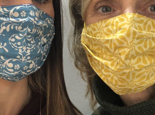 Custom face masks in blue and gold with floral patterns