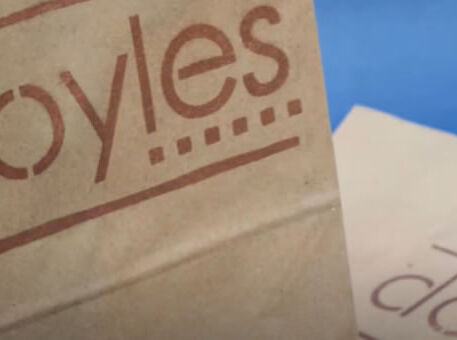 Paper bag with Doyles logo stencilled on