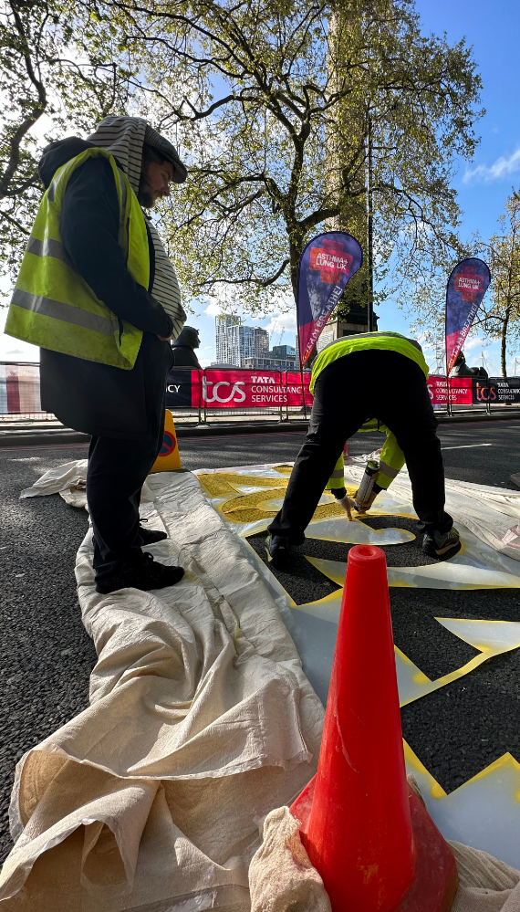 Temporary ground marking being applied on the road for the London Marathon